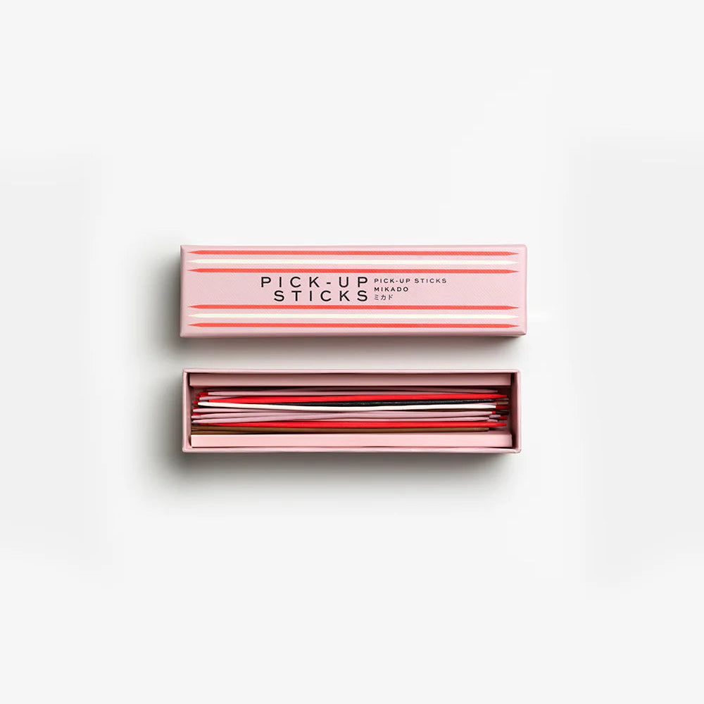 Set of pick-up sticks in a pink box on a white background