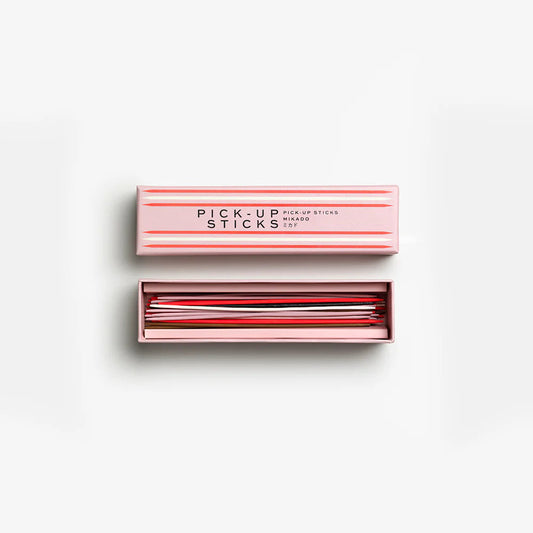 Set of pick-up sticks in a pink box on a white background