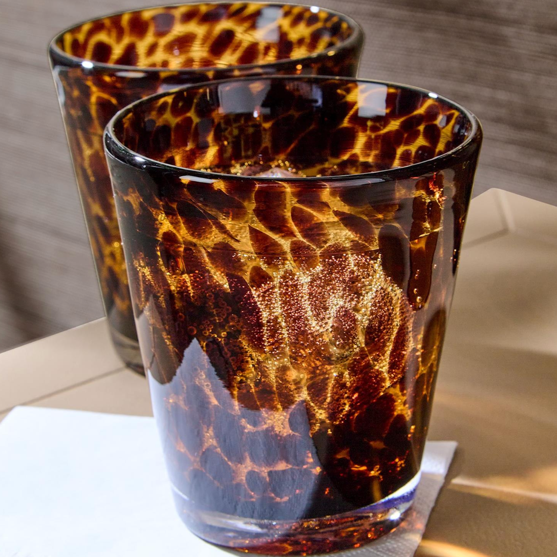 Two tortoiseshell-patterned glasses on a neutral background