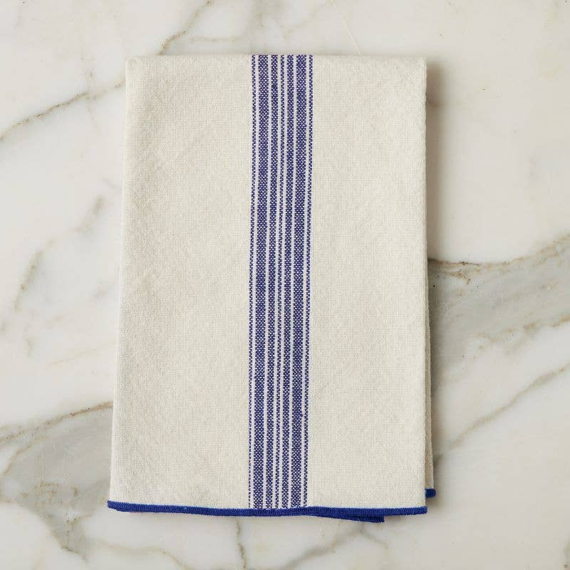 Beige towel with blue stripe on a marble surface