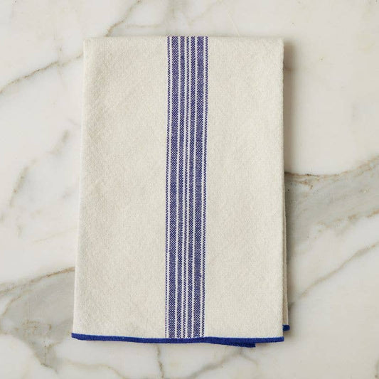Beige towel with blue stripe on a marble surface
